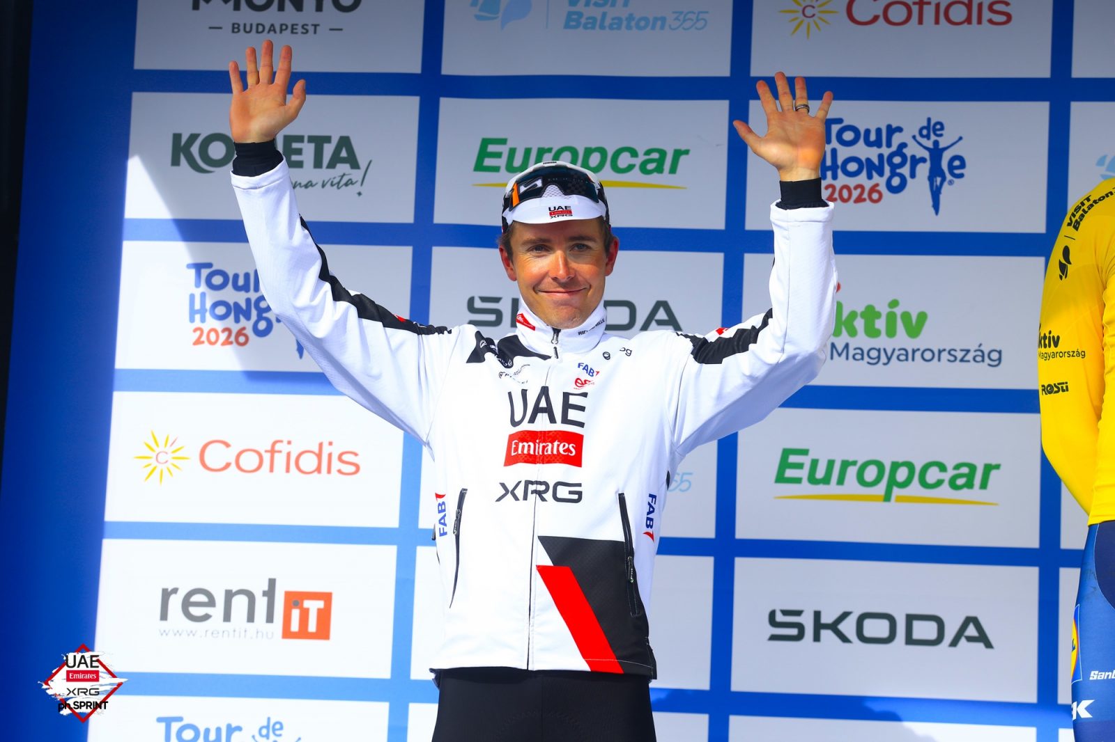 Benoît Cosnefroy waves to the crowd from the Tour de Hongrie podium